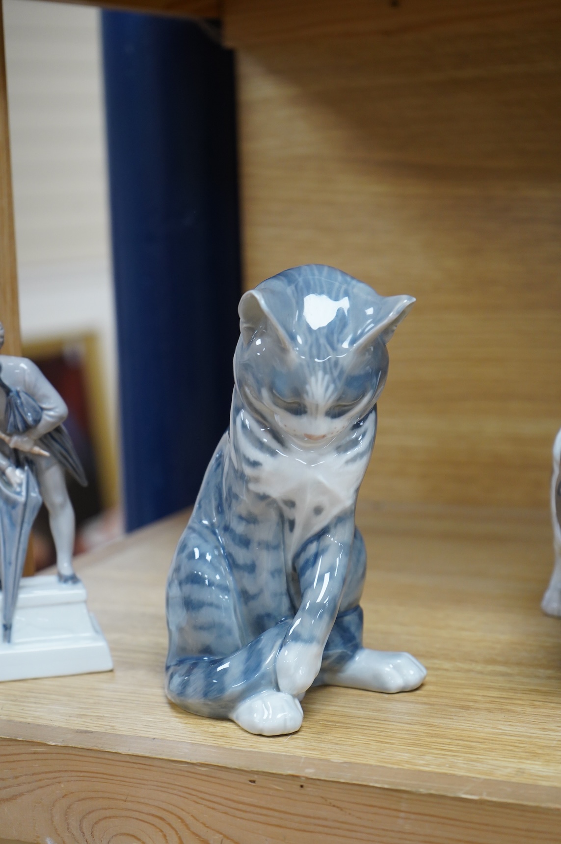 A Royal Copenhagen figure, 'The Sandman', Number 1129, a similar cat, number 340, a B&G spaniel and a Danish lion, tallest 18.5cm